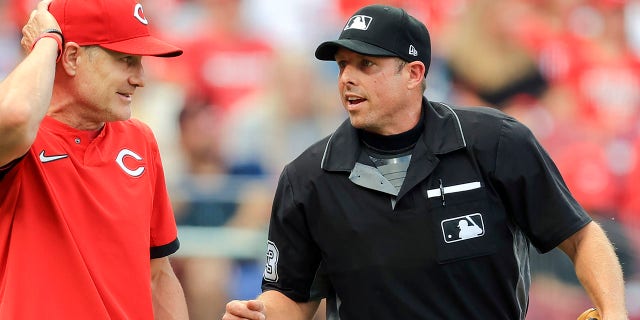 Cincinnati Reds manager David Bell, left, talks with umpire Tripp Gibson, right, between batters during the first inning of a baseball game against the San Diego Padres in Cincinnati, July 1, 2021.Â