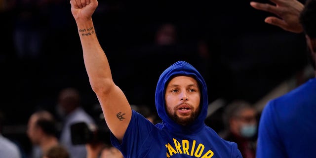 Golden State Warriors guard Stephen Curry gestures as he warms up before an NBA basketball game against the New York Knicks, Tuesday, Dec. 14, 2021, at Madison Square Garden in New York.