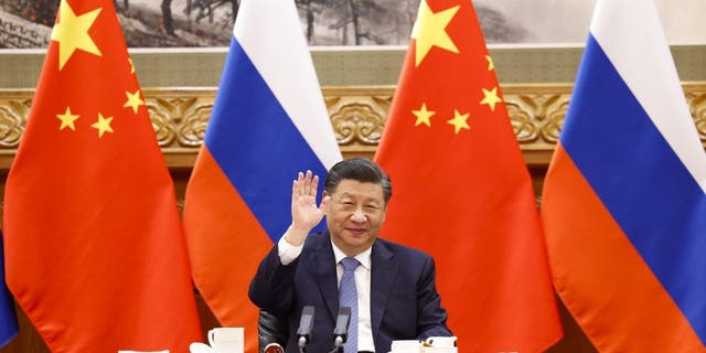 In this photo released by China's Xinhua News Agency, Chinese President Xi Jinping gestures during a virtual meeting with Russian President Vladimir Putin in Beijing, Wednesday, Dec. 15, 2021. Chinese President Xi Jinping supported Russian President Vladimir Putin in his push to get Western security guarantees precluding NATO's eastward expansion, the Kremlin said Wednesday after the two leaders held a virtual summit. (Huang Jingwen/Xinhua via AP)