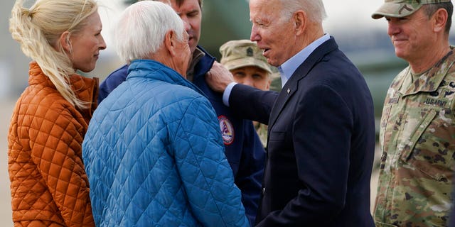 President Joe Biden greets former Gov. Steve Beshear, second from left, Kentucky Gov. Andy Beshear, third from left, and his wife Britainy Beshear, left, as he arrives in Fort Campbell, Ky., Wednesday, Dec. 15, 2021, to survey storm damage from tornadoes and extreme weather. Gen. Joseph P McGee, Commanding General, 101st Airborne Division is at right.