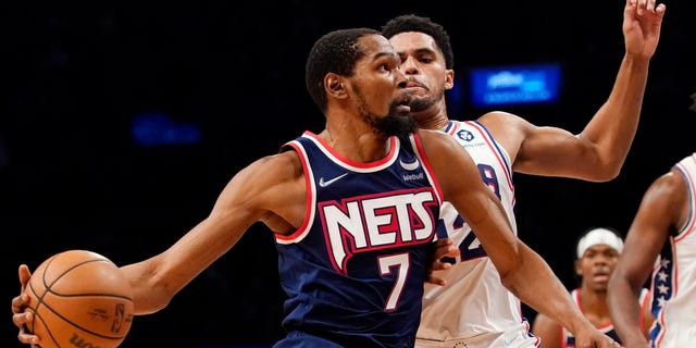 Brooklyn Nets forward Kevin Durant (7) drives to the basket against Philadelphia 76ers forward Tobias Harris (12) during the second half of an NBA basketball game, Thursday, December 16, 2021, in New York.  The Nets won 114-105. 