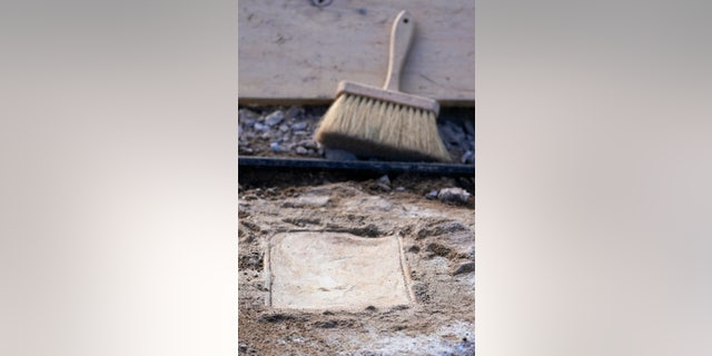 A time capsule that was placed in 1887 in the pedestal that once held the statue of Confederate General Robert E. Lee is uncovered on Monument Avenue, Friday Dec. 17, 2021, in Richmond, Va. (AP Photo/Steve Helber)