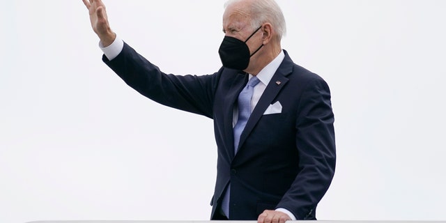 President Joe Biden waves as he boards Air Force One on Friday, Dec. 17, 2021.