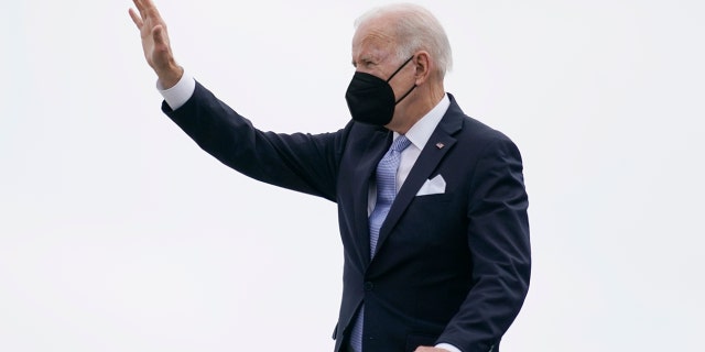 President Joe Biden waves as he boards Air Force One on Friday, Dec. 17, 2021.