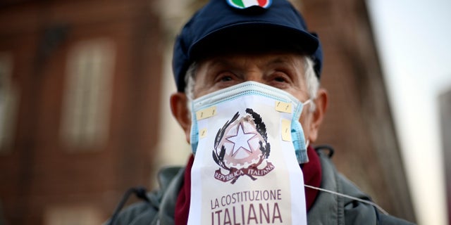 People gather to protest against Italy's covid Green Pass in Turin, Italy, Saturday Dec. 18, 2021. (Fabio Ferrari/LaPresse via AP)