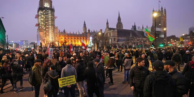 Anti -COVID-19 vaccination protesters demonstrate on Parliament Square in London, Saturday, Dec. 18, 2021. (Ian West/PA via AP)