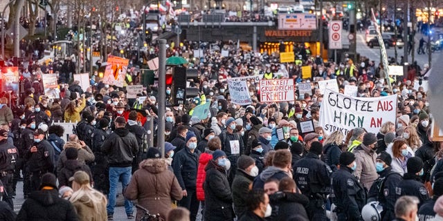 Participants gather to demonstrate against COVID-19 measures in downtown Hamburg, Saturday Dec. 18, 2021. (Markus Scholz/dpa via AP)