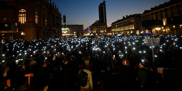 People gather to protest against Italy's COVID-19 Green Pass in Turin, Italy, Saturday Dec. 18, 2021. (Fabio Ferrari/LaPresse via AP)