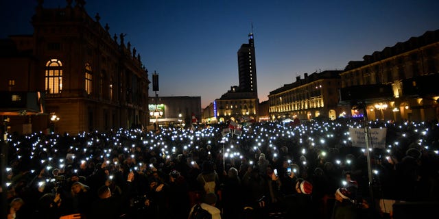People gather to protest against Italy's COVID-19 Green Pass in Turin, Italy, Saturday Dec. 18, 2021. (Fabio Ferrari/LaPresse via AP)