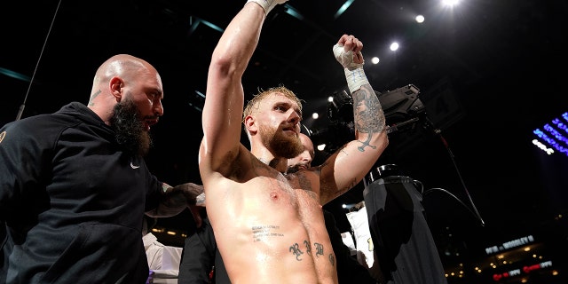 Jake Paul celebrates after knocking out Tyron Woodley during the sixth round of a Cruiserweight fight Sunday, Dec. 19, 2021, in Tampa, Fla. (AP Photo/Chris O'Meara)