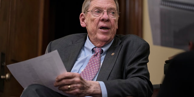 FILE - Sen. Johnny Isakson, R-Ga., meets with his staff in his office on Capitol Hill in Washington, Dec. 2, 2019. Isakson, an affable Georgia Republican politician who rose from the ranks of the state Legislature to become a U.S. senator, has died. He was 76. Georgia Gov. Brian Kemp’s office confirmed the death in a news release Sunday, Dec. 19, 2021. (AP Photo/J. Scott Applewhite, file)