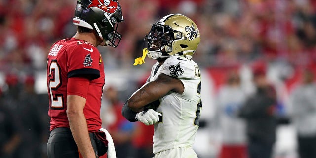 New Orleans Saints defensive back Chauncey Gardner-Johnson, right, taunts Tampa Bay Buccaneers quarterback Tom Brady after Brady fumbled the football during the second half of an NFL football game Sunday, Dec. 19, 2021, in Tampa, Fla. (AP Photo/Jason Behnken)