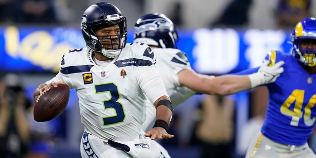 Seattle Seahawks quarterback Russell Wilson looks to throw during the first half of the team's NFL football game against the Los Angeles Rams on Tuesday, Dec. 21, 2021, in Inglewood, Calif. (AP Photo/Ashley Landis)