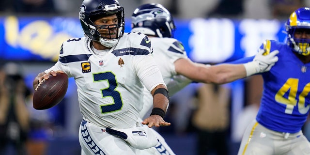 Seattle Seahawks quarterback Russell Wilson looks to throw against the Los Angeles Rams on Tuesday, Dec. 21, 2021, in Inglewood, California.