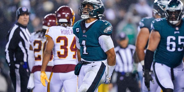 Philadelphia Eagles quarterback Jalen Hurts, center, celebrates after scoring a touchdown during the second half of an NFL football game against the Washington Football Team, Tuesday, Dec. 21, 2021, in Philadelphia. (AP Photo/Matt Slocum)