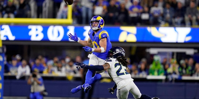 Los Angeles Rams wide receiver Cooper Kupp, top, catches a pass over Seattle Seahawks cornerback Sidney Jones during the second half of an NFL football game Tuesday, Dec. 21, 2021, in Inglewood, Calif. (AP Photo/Ashley Landis)