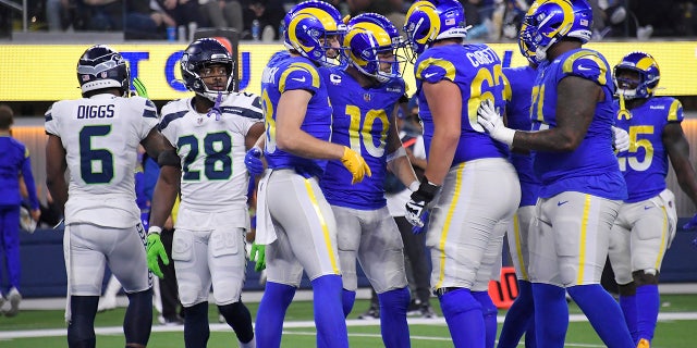 Los Angeles Rams wide receiver Cooper Kupp (10) celebrates his touchdown catch with teammates during the second half of an NFL football game against the Seattle Seahawks on Tuesday, Dec. 21, 2021, in Inglewood, Calif. (AP Photo/Kevork Djansezian)
