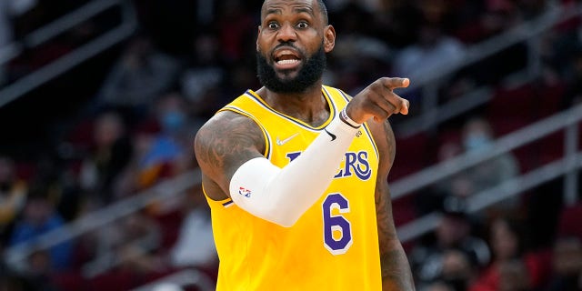 Los Angeles Lakers forward LeBron James talks to teammates during the first half of an NBA basketball game against the Houston Rockets, Tuesday, Dec. 28, 2021, in Houston.