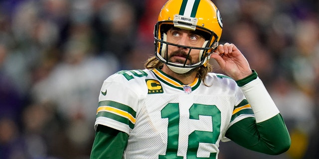 Green Bay Packers quarterback Aaron Rodgers walks off the field after not being able to convert for a first down in the first half of an NFL football game against the Baltimore Ravens, Sunday, Dec. 19, 2021, in Baltimore.