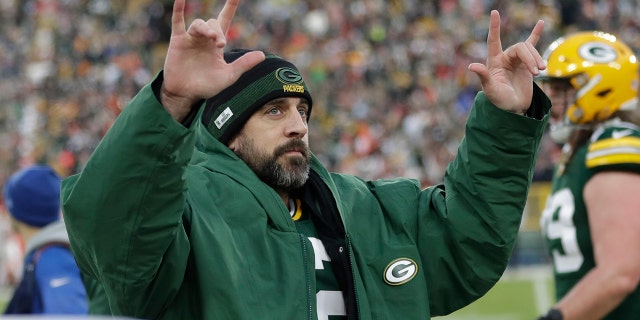 Green Bay Packers' Aaron Rodgers celebrates after throwing career touchdown pass 443 during the first half of an NFL football game against the Cleveland Browns Saturday, Dec. 25, 2021, in Green Bay, Wisconsin. The pass breaks the previous Green Bay Packers record held by Brett Favre.