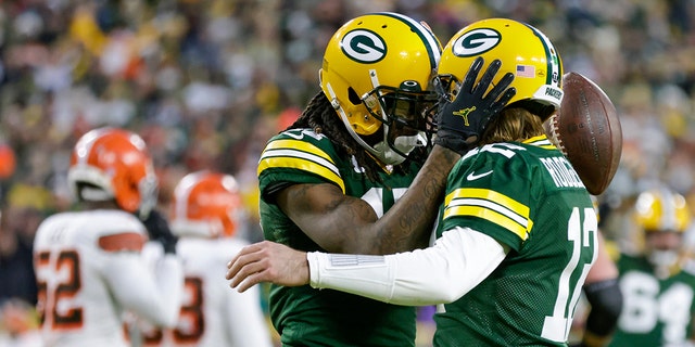 Green Bay Packers' Davante Adams celebrates his touchdown reception with Aaron Rodgers during the first half of an NFL football game against the Cleveland Browns Saturday, Dec. 25, 2021, in Green Bay, Wis.