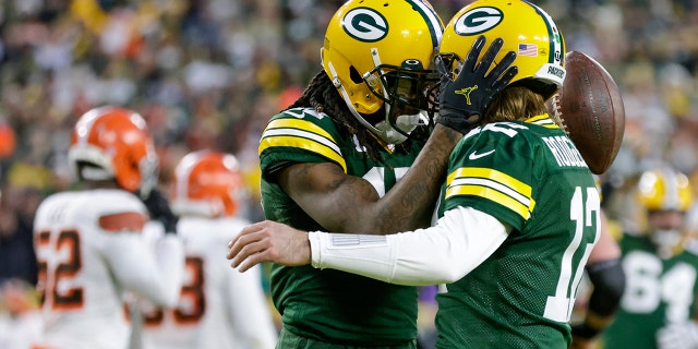 Green Bay Packers' Davante Adams celebrates his touchdown reception with Aaron Rodgers during the first half of an NFL football game against the Cleveland Browns Saturday, Dec. 25, 2021, in Green Bay, Wis.