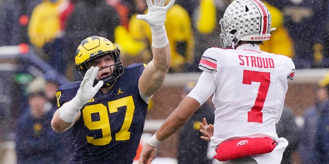 Michigan defensive end Aidan Hutchinson (97) rushes Ohio State quarterback C.J. Stroud (7) during the first half of an NCAA college football game, Saturday, Nov. 27, 2021, in Ann Arbor, Mich.