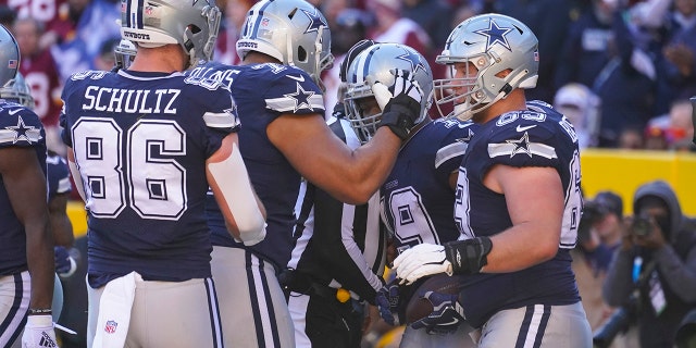 Dallas Cowboys wide receiver Amari Cooper (19) celebrates his touchdown against the Washington Football Team during the first half of a game Sunday, Dec. 12, 2021, in Landover, Md.