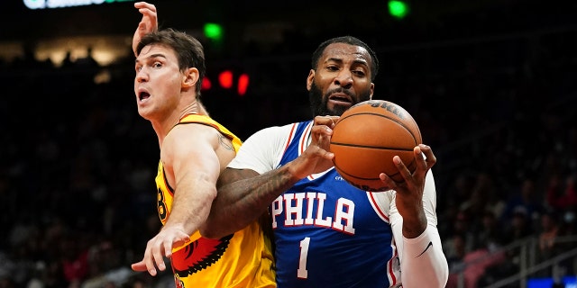 Philadelphia 76ers center Andre Drummond (1) pulls down a rebound in front of Atlanta Hawks forward Danilo Gallinari (8) during the second half Friday, Dec. 3, 2021, in Atlanta.