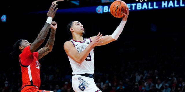 Gonzaga guard Andrew Nembhard, right, goes up for a shot against Texas Tech guard Davion Warren, left, during the first half of an NCAA college basketball game at the Jerry Colangelo Classic Saturday, Dec. 18, 2021, in Phoenix.