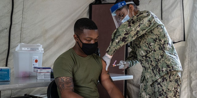 A United States Marine receives the Moderna coronavirus vaccine at Camp Foster April 28, 2021, in Ginowan, Japan. 