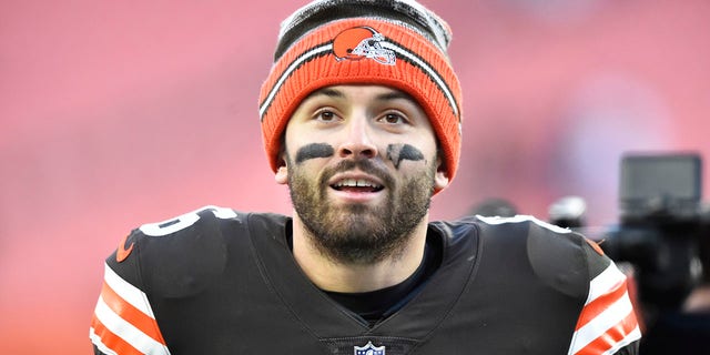FILE - Cleveland Browns quarterback Baker Mayfield walks off the field after his team defeated the Baltimore Ravens in an NFL football game, Sunday, Dec. 12, 2021, in Cleveland.  Mayfield and coach Kevin Stefanski tested positive for COVID-19 on Wednesday, Dec. 15,  and will likely miss Saturday’s game against the Las Vegas Raiders as Cleveland deals with a widespread outbreak during its playoff pursuit.