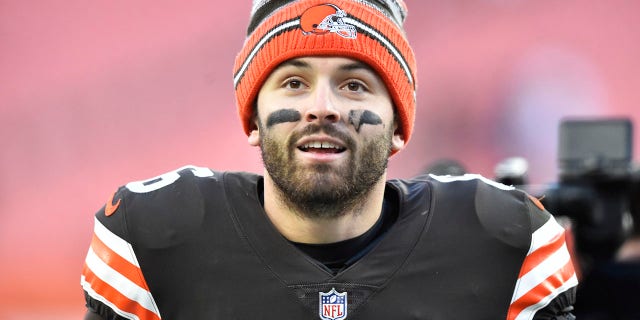 FILE - Cleveland Browns quarterback Baker Mayfield walks off the field after his team defeated the Baltimore Ravens in an NFL football game, Sunday, Dec. 12, 2021, in Cleveland.  Mayfield and coach Kevin Stefanski tested positive for COVID-19 on Wednesday, Dec. 15,  and will likely miss Saturday’s game against the Las Vegas Raiders as Cleveland deals with a widespread outbreak during its playoff pursuit.