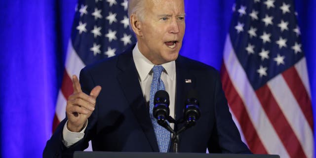 President Joe Biden speaks during the holiday celebration for the Democratic National Committee in Washington on Dec. 14, 2021.