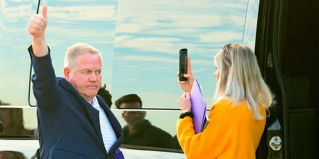 New LSU football coach Brian Kelly gestures to fans after his arrival at Baton Rouge Metropolitan Airport, Tuesday, Nov. 30, 2021, in Baton Rouge, Louisiana.