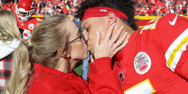 Kansas City Chiefs quarterback Patrick Mahomes kisses his fiancee Brittany Matthews before an NFL game.