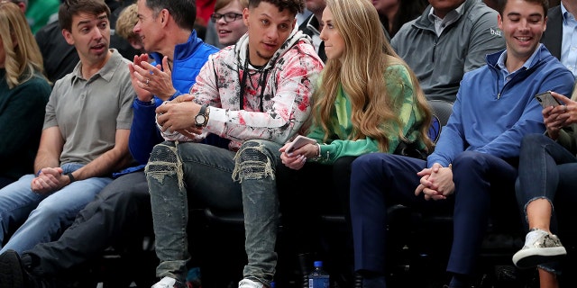 Patrick Mahomes #15 of the Kansas City Chiefs and girlfriend, Brittany Matthews, look on as the Dallas Mavericks take on the New Orleans Pelicans at American Airlines Center on March 04, 2020 in Dallas, Texas.