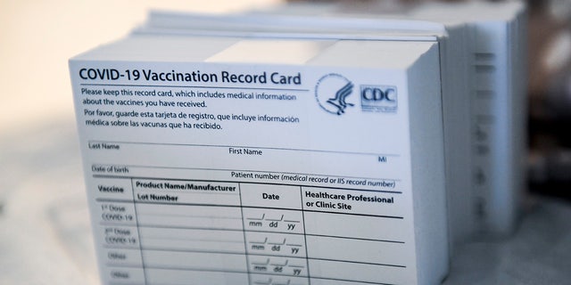 A stack of COVID-19 Vaccination Record Cards from the CDC.  