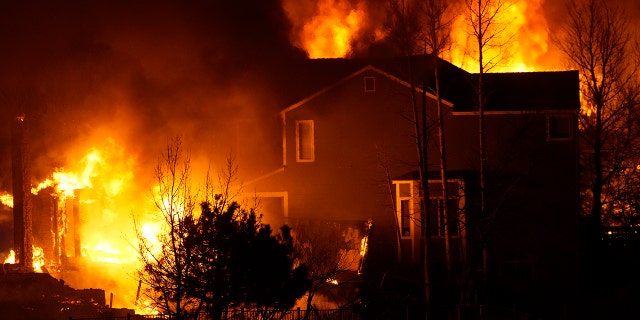 Homes burn as wildfires rip through a development Thursday, Dec. 30, 2021, in Superior, Colorado.