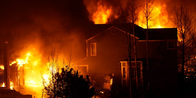 Homes burn as wildfires rip through a development Thursday, Dec. 30, 2021, in Superior, Colorado.