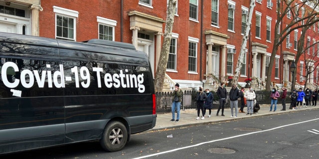 A line stretches down the block as people wait in line to be tested for COVID-19 in New York on Thursday, Dec. 16, 2021.  