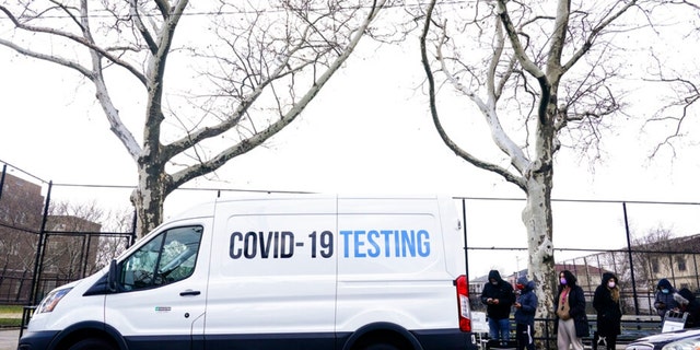 People line up for at a CDC mobile COVID-19 testing location Thursday, Dec. 23, 2021, in the Queens borough of New York. (AP Photo/Frank Franklin II) 