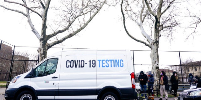 People line up for at a CDC mobile COVID-19 testing location Thursday, Dec. 23, 2021, in the Queens borough of New York. (AP Photo/Frank Franklin II)