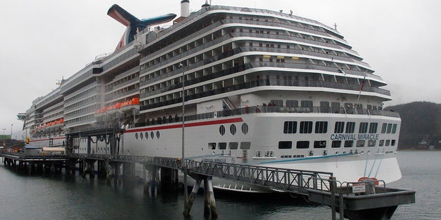 FILE 2013: The Carnival Miracle docked in Juneau, Alaska. U.S. Coast Guard authorities have halted the search for a woman who reportedly went overboard on the cruise ship near Ensenada, Mexico. Petty Officer First Class Adam Stanton says authorities searched more than 31 hours for the woman before pausing the search on Sunday, Dec. 12, 2021, pending additional information. (AP Photo/Becky Bohrer, File)