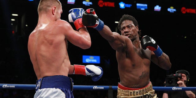 Charles Martin (gold/black) throws a right hand against Vyacheslav Glazkov at the Barclays Center in the Brooklyn borough of New York City on Jan. 16, 2016. Martin would win in the third round when Glazkov was unable to continue.