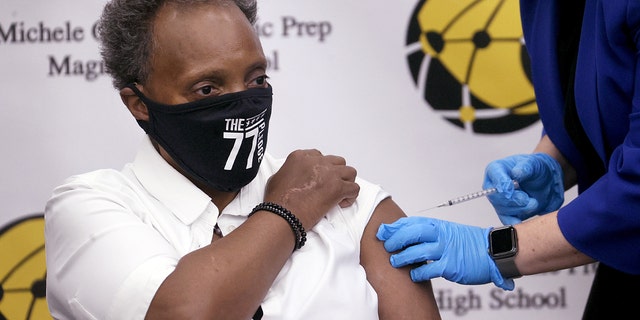 CHICAGO, ILLINOIS - NOVEMBER 12: Chicago Mayor Lori Lightfoot gets a COVID-19 booster vaccine at Michele Clark High School on Nov. 12, 2021 in Chicago, Ill.