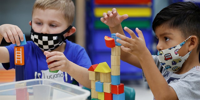 Children wear a masks and wait for President Biden to visit her pre-Kindergarten class at East End Elementary School to highlight the early childhood education proposal in his Build Back Better infrastructure agenda in North Plainfield, New Jersey, Oct. 25, 2021.