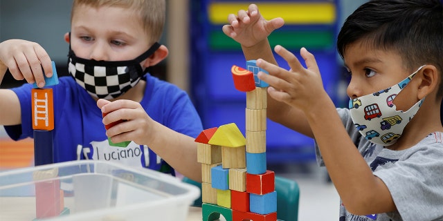 Children wear a masks and wait for President Biden to visit her pre-Kindergarten class at East End Elementary School to highlight the early childhood education proposal in his Build Back Better infrastructure agenda in North Plainfield, New Jersey, Oct. 25, 2021.