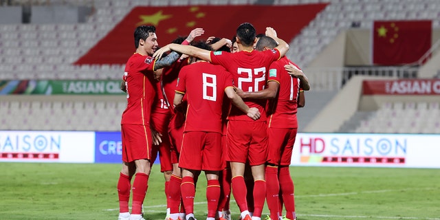 Members of China PR celebrate scoring their first goal during the FIFA World Cup Asian Qualifier final round Group B match between China and Vietnam at Sharjah Stadium on Oct. 7, 2021, in Sharjah, United Arab Emirates.