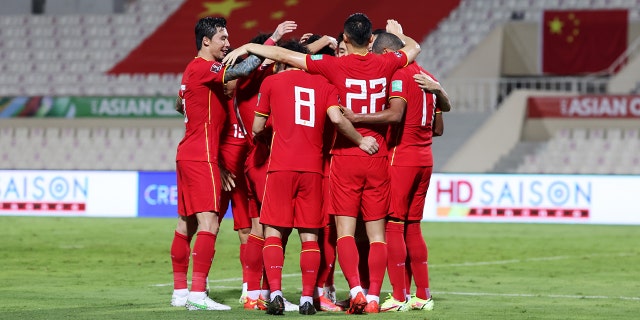 Members of China PR celebrate scoring their first goal during the FIFA World Cup Asian Qualifier final round Group B match between China and Vietnam at Sharjah Stadium on Oct. 7, 2021, in Sharjah, United Arab Emirates.